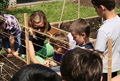 French Road parent Jessie Nimeh helping students plant the garden